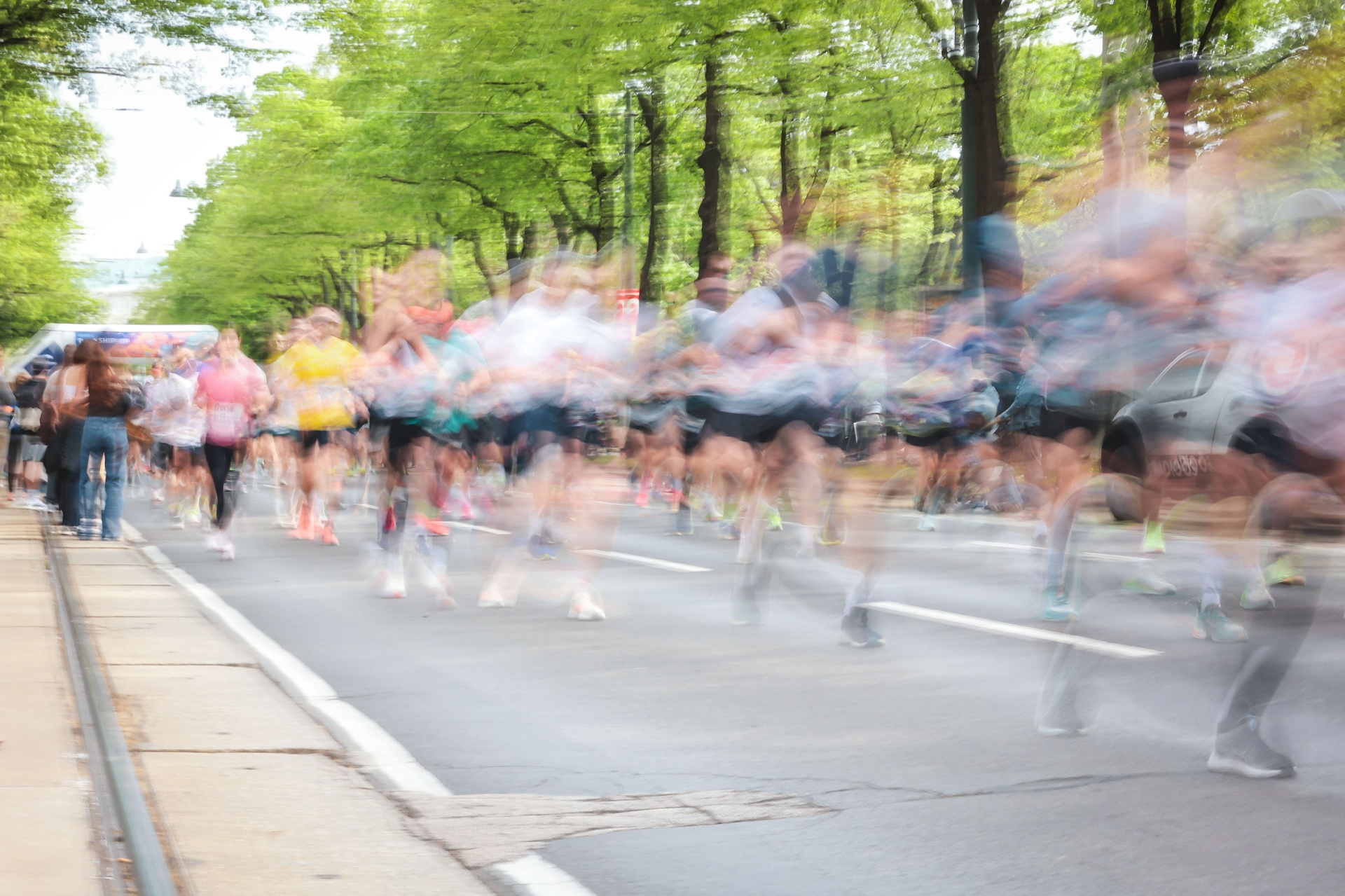 Motion-blurred pack of runners at the start of a race